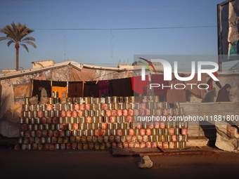 A displaced Palestinian stands in front of his tent in Deir al-Balah, on December 19, 2024, as the war between Israel and Hamas militants co...