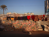 A displaced Palestinian stands in front of his tent in Deir al-Balah, on December 19, 2024, as the war between Israel and Hamas militants co...