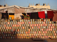 A displaced Palestinian stands in front of his tent in Deir al-Balah, on December 19, 2024, as the war between Israel and Hamas militants co...