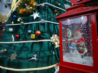 A mythical Santa Claus is on display next to the artificial Christmas tree set at the entrance of a mall in Kathmandu, Nepal, on December 19...