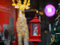 A mythical Santa Claus is on display next to the artificial Christmas tree set at the entrance of a mall in Kathmandu, Nepal, on December 19...