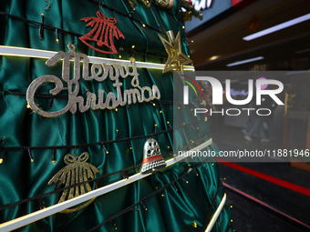 Text reading Merry Christmas is embedded in the decorations of a Christmas tree set at the entrance of a mall in Kathmandu, Nepal, on Decemb...