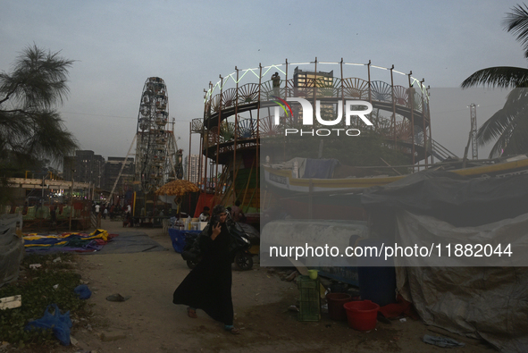 A police officer stands near a Mahim fair in Mumbai, India, on December 19, 2024. 