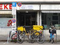 In Munich, Bavaria, Germany, on December 19, 2024, a Deutsche Post delivery bicycle is parked outside a residential building as postal worke...