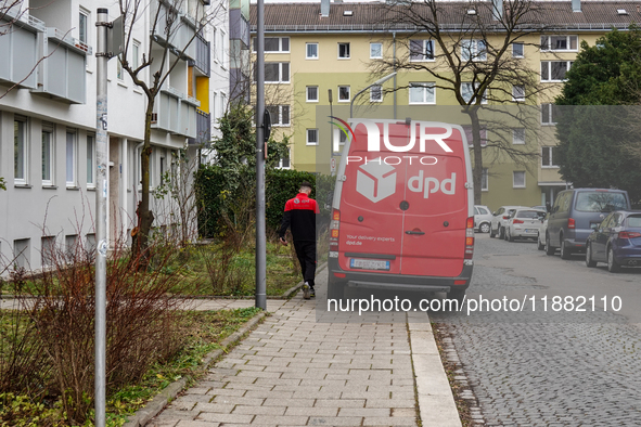 A DPD delivery van parks in front of a residential building in Munich, Bavaria, Germany, on December 19, 2024. 