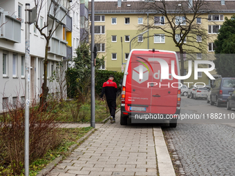 A DPD delivery van parks in front of a residential building in Munich, Bavaria, Germany, on December 19, 2024. (