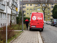 A DPD delivery van parks in front of a residential building in Munich, Bavaria, Germany, on December 19, 2024. (