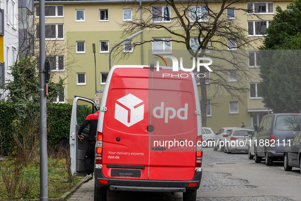 A DPD delivery van parks in front of a residential building in Munich, Bavaria, Germany, on December 19, 2024. 