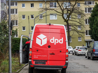 A DPD delivery van parks in front of a residential building in Munich, Bavaria, Germany, on December 19, 2024. (