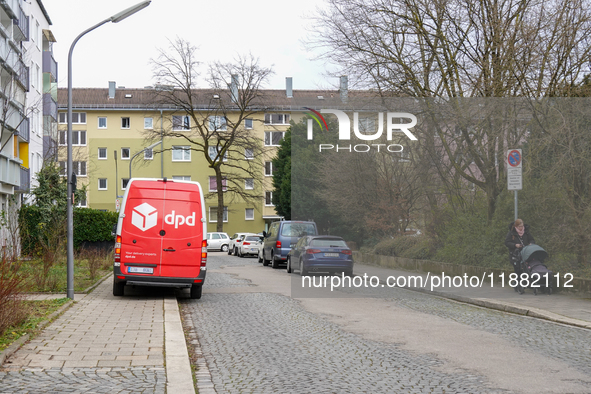 A DPD delivery van parks in front of a residential building in Munich, Bavaria, Germany, on December 19, 2024. 