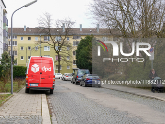 A DPD delivery van parks in front of a residential building in Munich, Bavaria, Germany, on December 19, 2024. (