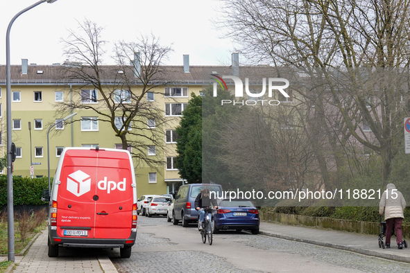 A DPD delivery van parks in front of a residential building in Munich, Bavaria, Germany, on December 19, 2024. 