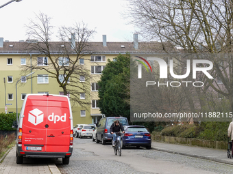 A DPD delivery van parks in front of a residential building in Munich, Bavaria, Germany, on December 19, 2024. (