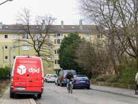 A DPD delivery van parks in front of a residential building in Munich, Bavaria, Germany, on December 19, 2024. (