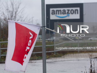 A Verdi flag is placed in front of an Amazon site in Werne, Germany, on December 19, 2024, as the Verdi labor union calls for a strike and d...