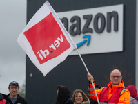 Several workers stand in front of an Amazon site in Werne, Germany, on December 19, 2024, as the Verdi labor union calls for a strike and de...