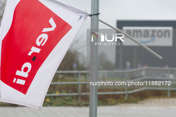 A Verdi flag is placed in front of an Amazon site in Werne, Germany, on December 19, 2024, as the Verdi labor union calls for a strike and d...