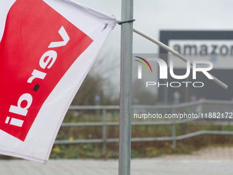 A Verdi flag is placed in front of an Amazon site in Werne, Germany, on December 19, 2024, as the Verdi labor union calls for a strike and d...