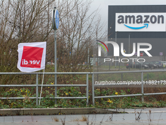 A Verdi flag is placed in front of an Amazon site in Werne, Germany, on December 19, 2024, as the Verdi labor union calls for a strike and d...