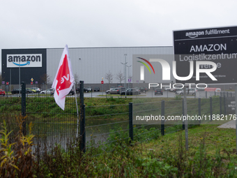 A Verdi flag is placed in front of an Amazon site in Werne, Germany, on December 19, 2024, as the Verdi labor union calls for a strike and d...