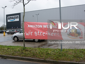 A strike banner is placed in front of an Amazon site in Werne, Germany, on December 19, 2024, as the Verdi labor union calls for a strike an...