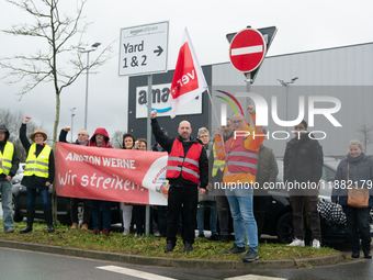 Several workers stand in front of an Amazon site in Werne, Germany, on December 19, 2024, as the Verdi labor union calls for a strike and de...