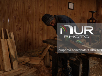 Employees working inside a Kashmir Willow bat making factory on a cold winter day in Bijbehara, Jammu and Kashmir India on 19 December 2024...