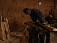 Employees working inside a Kashmir Willow bat making factory on a cold winter day in Bijbehara, Jammu and Kashmir India on 19 December 2024...