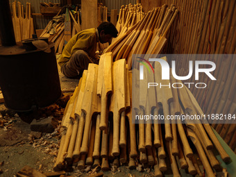 Employees work inside a Kashmir Willow bat-making factory in Bijbehara, Jammu and Kashmir, India, on December 19, 2024, on a cold winter day...