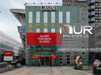 The facade of Casino Innsbruck with its red banner 'Alles fur dein Gluck!' ('Everything for your luck!') is displayed alongside promotional...