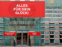 The facade of Casino Innsbruck with its red banner 'Alles fur dein Gluck!' ('Everything for your luck!') is displayed alongside promotional...