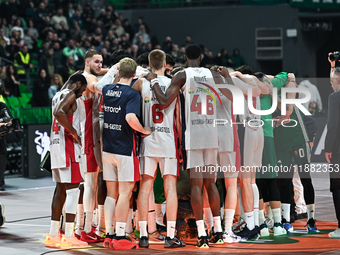 Players from Baskonia Vitoria-Gasteiz and Panathinaikos AKTOR Athens pray together for Mathias Lessort after he is injured following the Eur...