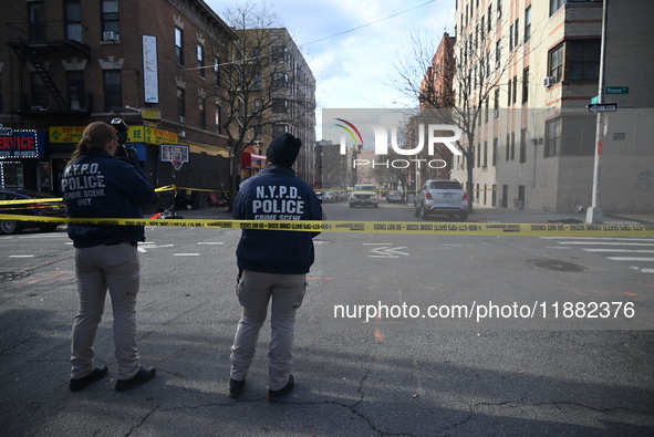 The NYPD Crime Scene Unit places evidence markers at the scene to highlight the weapon and other evidence found where an unidentified man is...