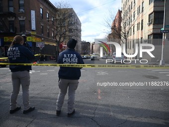 The NYPD Crime Scene Unit places evidence markers at the scene to highlight the weapon and other evidence found where an unidentified man is...