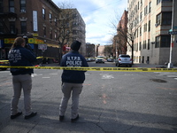 The NYPD Crime Scene Unit places evidence markers at the scene to highlight the weapon and other evidence found where an unidentified man is...