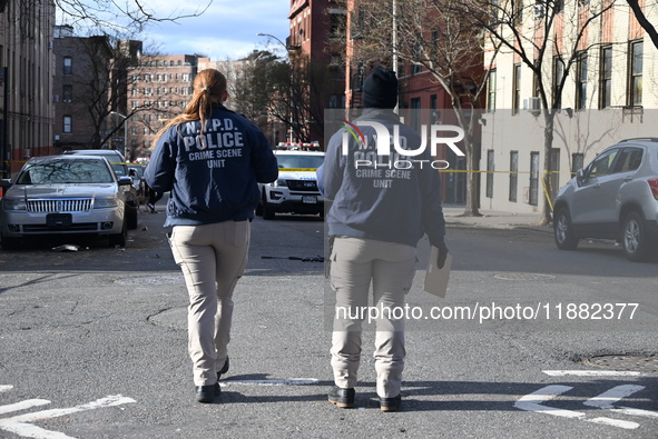 The NYPD Crime Scene Unit places evidence markers at the scene to highlight the weapon and other evidence found where an unidentified man is...