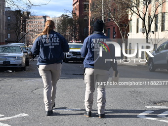 The NYPD Crime Scene Unit places evidence markers at the scene to highlight the weapon and other evidence found where an unidentified man is...