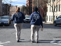 The NYPD Crime Scene Unit places evidence markers at the scene to highlight the weapon and other evidence found where an unidentified man is...