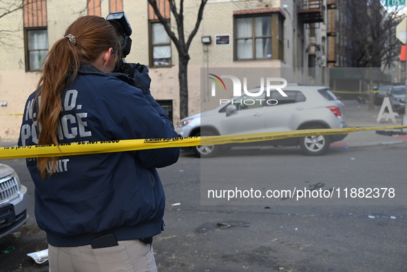 The NYPD Crime Scene Unit places evidence markers at the scene to highlight the weapon and other evidence found where an unidentified man is...