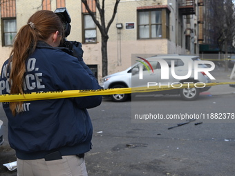 The NYPD Crime Scene Unit places evidence markers at the scene to highlight the weapon and other evidence found where an unidentified man is...