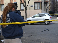 The NYPD Crime Scene Unit places evidence markers at the scene to highlight the weapon and other evidence found where an unidentified man is...