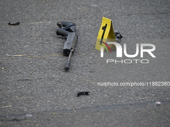 The NYPD Crime Scene Unit places evidence markers at the scene to highlight the weapon and other evidence found where an unidentified man is...