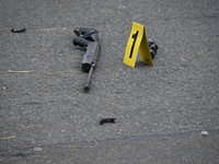 The NYPD Crime Scene Unit places evidence markers at the scene to highlight the weapon and other evidence found where an unidentified man is...