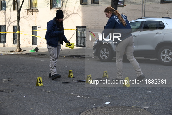 The NYPD Crime Scene Unit places evidence markers at the scene to highlight the weapon and other evidence found where an unidentified man is...