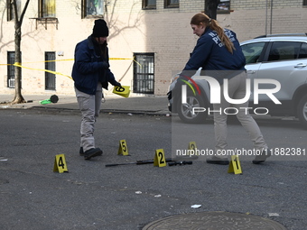 The NYPD Crime Scene Unit places evidence markers at the scene to highlight the weapon and other evidence found where an unidentified man is...