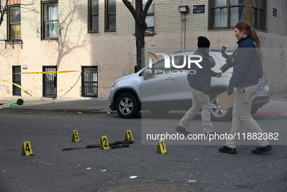 The NYPD Crime Scene Unit places evidence markers at the scene to highlight the weapon and other evidence found where an unidentified man is...