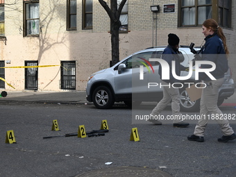 The NYPD Crime Scene Unit places evidence markers at the scene to highlight the weapon and other evidence found where an unidentified man is...