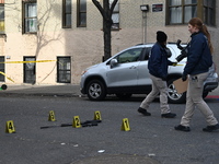 The NYPD Crime Scene Unit places evidence markers at the scene to highlight the weapon and other evidence found where an unidentified man is...