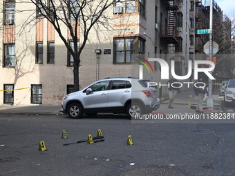 The NYPD Crime Scene Unit places evidence markers at the scene to highlight the weapon and other evidence found where an unidentified man is...