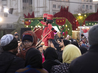 Young puppeteers perform with two Iranian traditional puppets during a pomegranate festival on Yalda Night Eve in the Abasabad tourism zone...